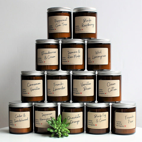 Stack of candles with labeled lids on a white background